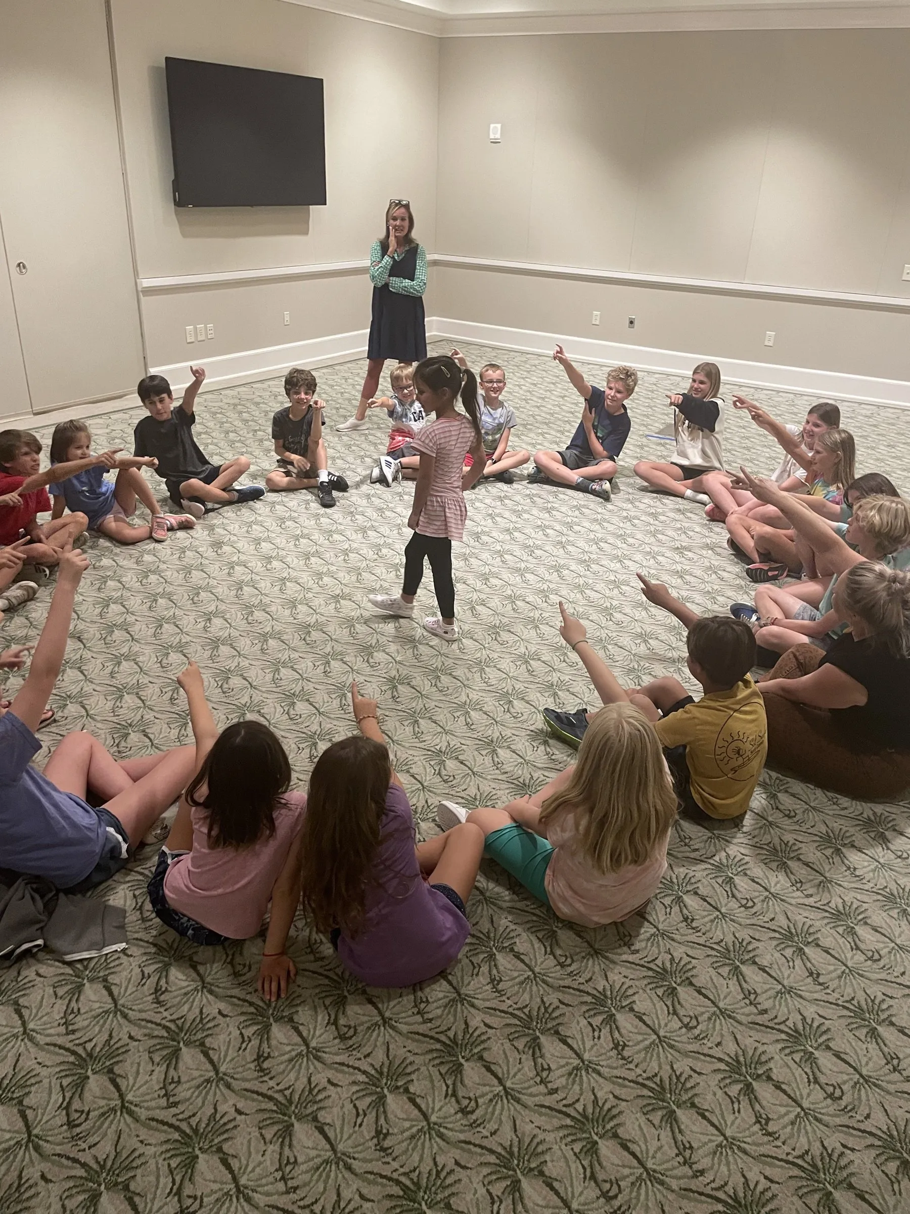 Students sitting in a circle working together while Simone leads