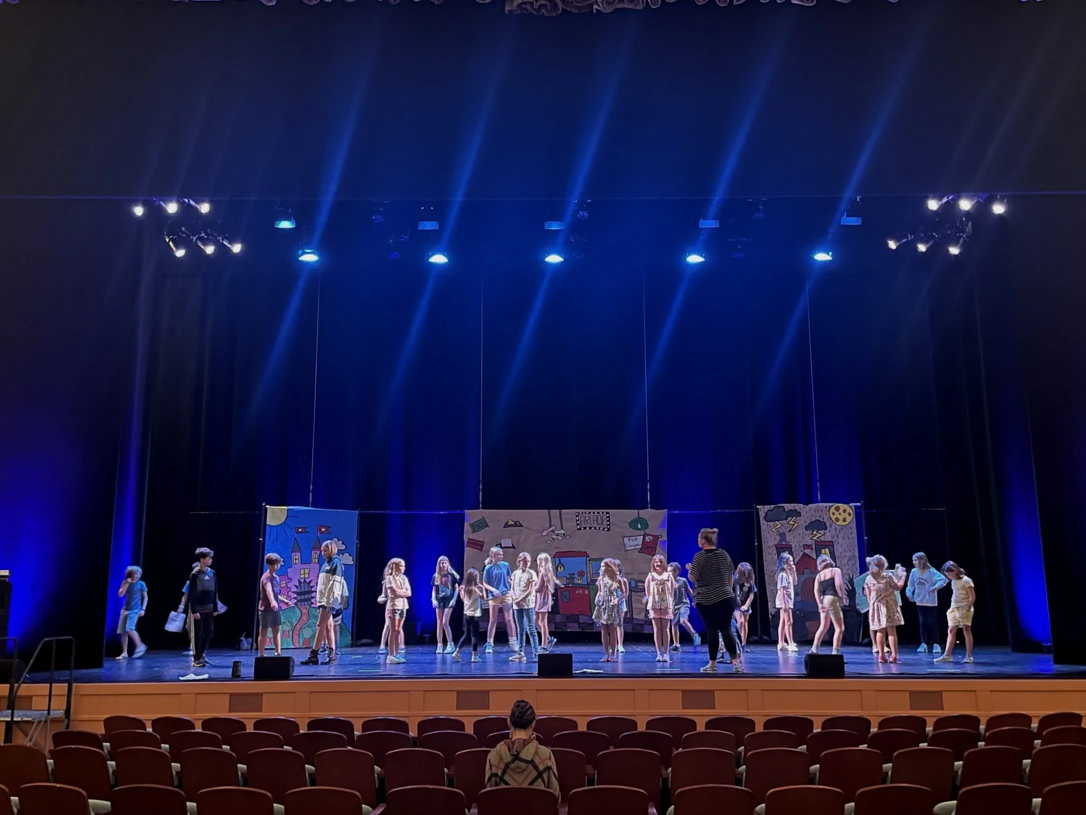 Summer camp students performing a show on stage